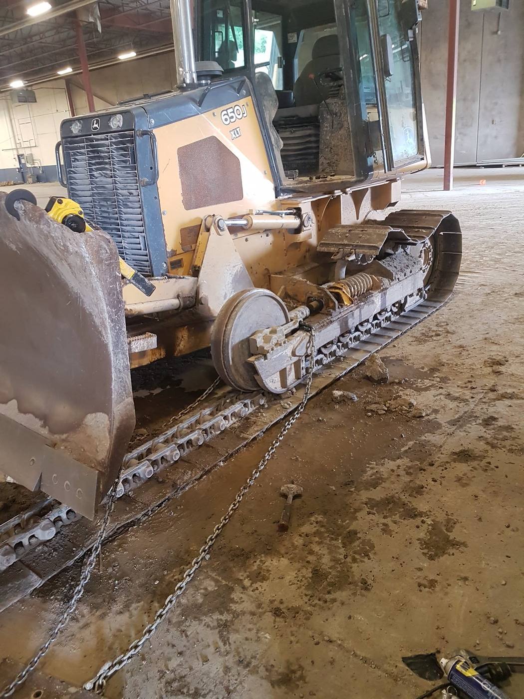 John Deere 650J XLT crawler dozer with track separated for undercarriage and idler repair
